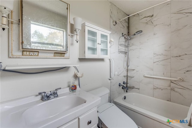 full bathroom with vanity, tiled shower / bath combo, and toilet