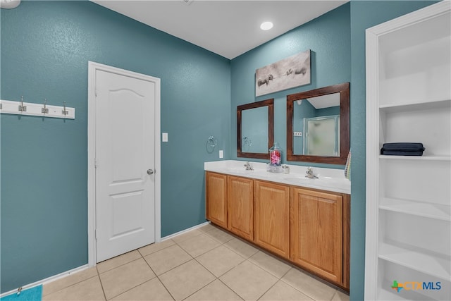 bathroom featuring tile patterned flooring, built in shelves, and vanity