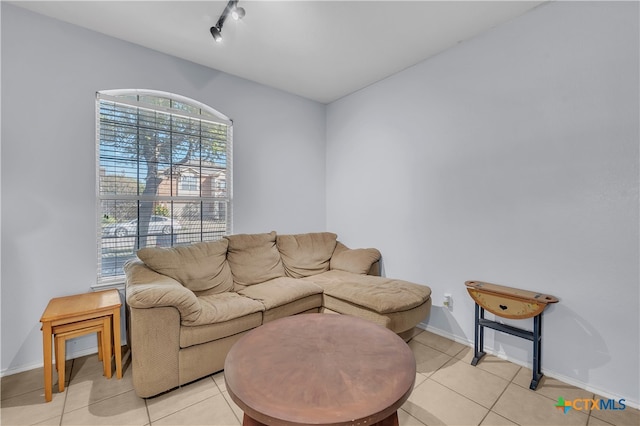 living room with light tile patterned flooring and rail lighting