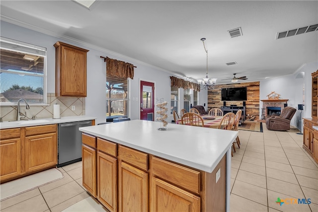 kitchen with dishwasher, a center island, sink, backsplash, and crown molding