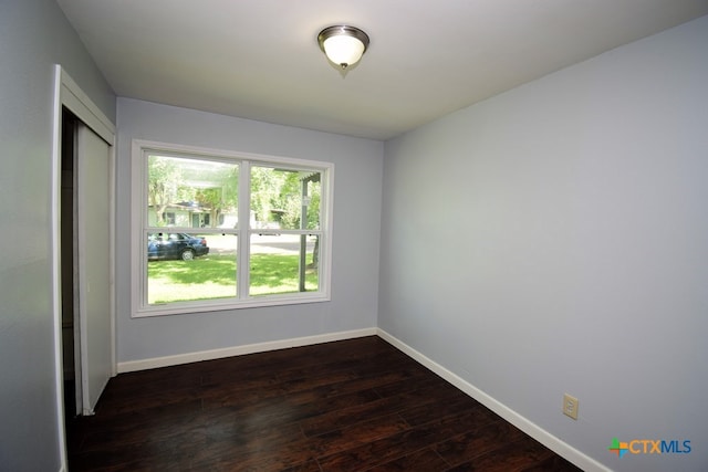 empty room featuring dark hardwood / wood-style flooring