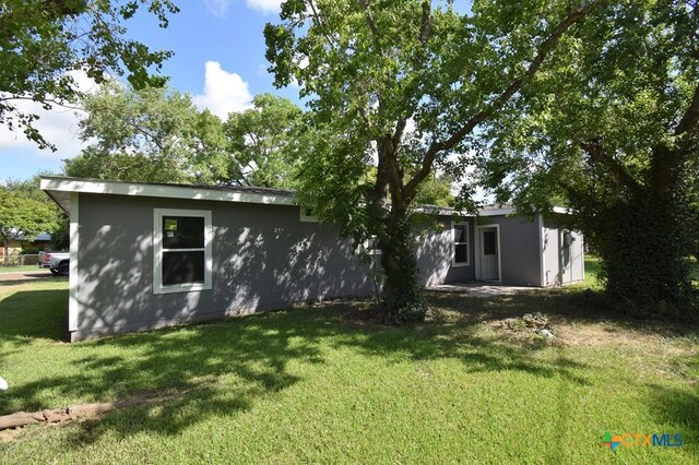 rear view of house with a yard