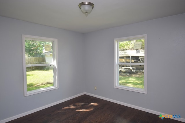 spare room featuring dark wood-type flooring