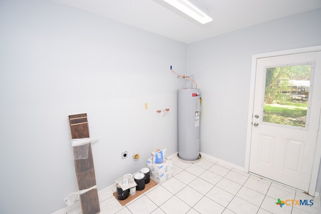 laundry room featuring electric water heater, electric dryer hookup, and light tile patterned floors