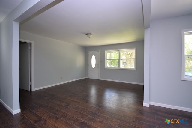 interior space with a healthy amount of sunlight and dark hardwood / wood-style floors