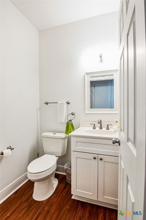 bathroom with vanity, hardwood / wood-style floors, and toilet