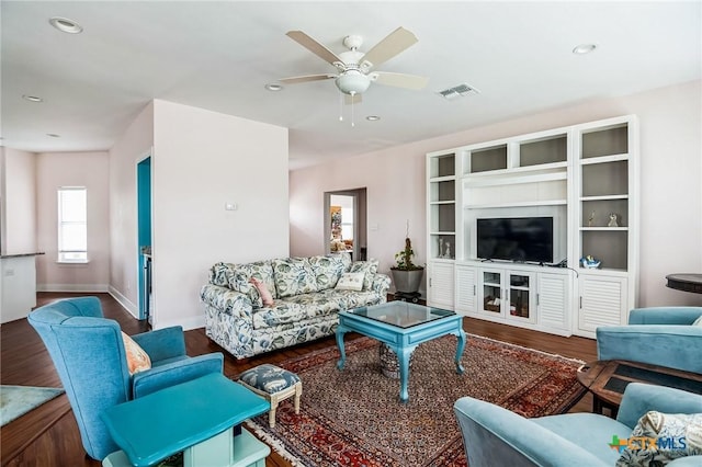 living room with wood-type flooring and ceiling fan