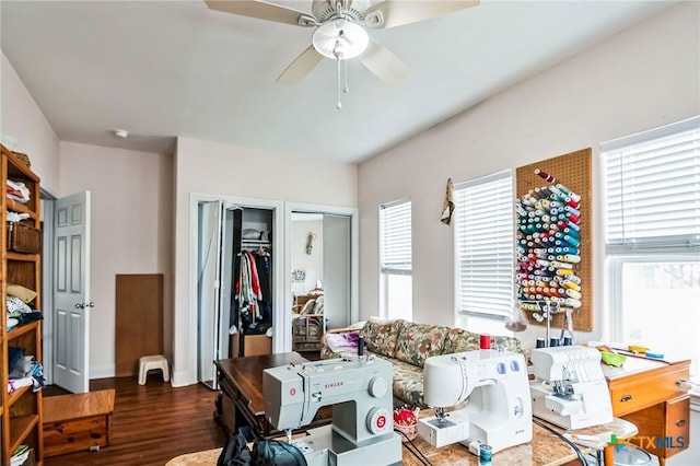 living room with dark wood-type flooring and ceiling fan