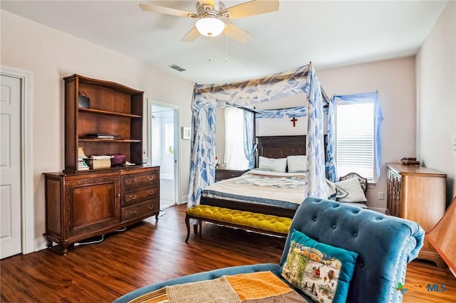 bedroom featuring multiple windows, dark hardwood / wood-style flooring, and ceiling fan