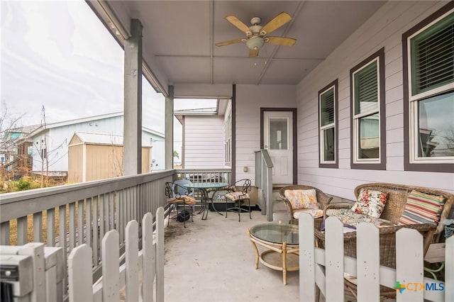 sunroom / solarium with ceiling fan and a skylight