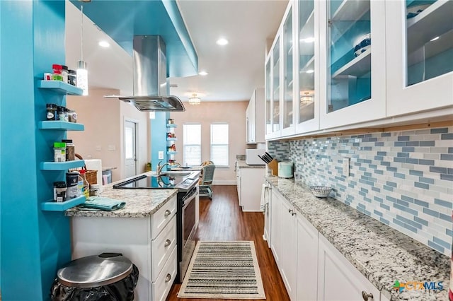 kitchen with white cabinetry, stainless steel range with electric stovetop, light stone countertops, and island exhaust hood