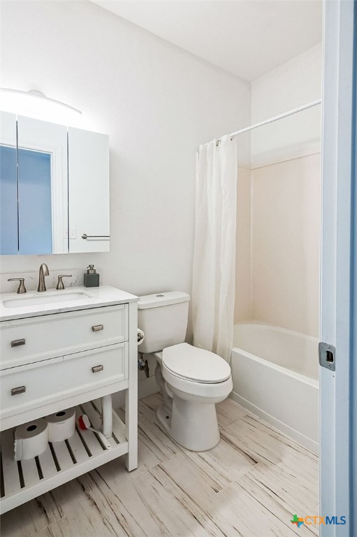 full bathroom featuring vanity, shower / bath combination with curtain, and toilet