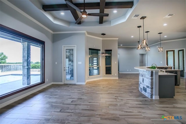 809 Reston Rd, Temple, TX 76502 - kitchen with a kitchen island with sink, coffered ceiling, a ceiling fan, light countertops, and open floor plan