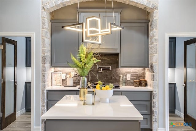 809 Reston Rd, Temple, TX 76502 - kitchen featuring gray cabinetry, wood finished floors, decorative backsplash, and light countertops