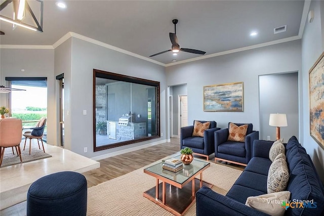 809 Reston Rd, Temple, TX 76502 - living area with wood finished floors, a ceiling fan, crown molding, recessed lighting, and baseboards