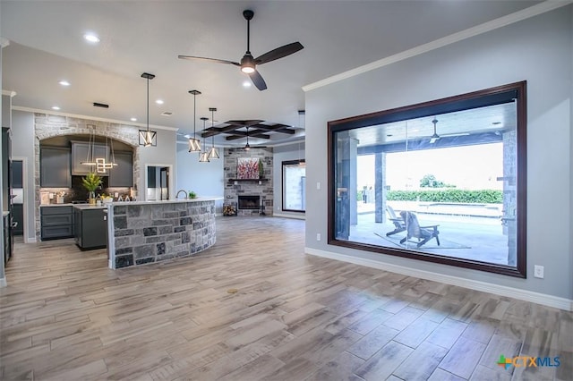 809 Reston Rd, Temple, TX 76502 - living area featuring light wood finished floors, ornamental molding, ceiling fan, a fireplace, and recessed lighting