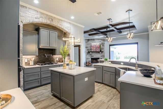 809 Reston Rd, Temple, TX 76502 - kitchen featuring gray cabinetry, a sink, a center island, coffered ceiling, and tasteful backsplash