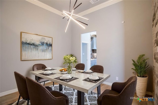 809 Reston Rd, Temple, TX 76502 - dining area with wood finished floors, a chandelier, baseboards, and crown molding