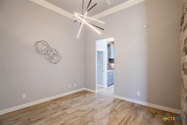809 Reston Rd, Temple, TX 76502 - unfurnished room featuring light wood-style floors, a chandelier, ornamental molding, and baseboards