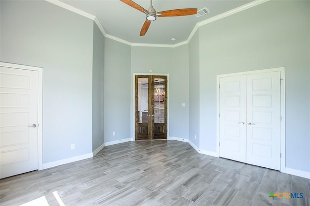 809 Reston Rd, Temple, TX 76502 - unfurnished bedroom featuring ornamental molding, french doors, high vaulted ceiling, baseboards, and light wood-style flooring