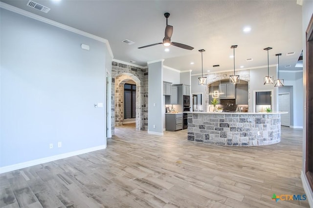 809 Reston Rd, Temple, TX 76502 - unfurnished living room with arched walkways, ceiling fan, ornamental molding, light wood-type flooring, and baseboards