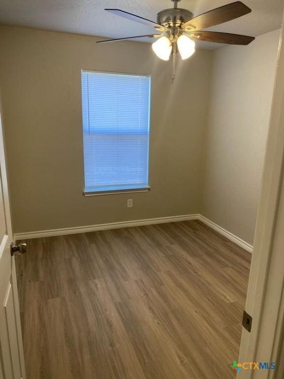 empty room featuring hardwood / wood-style flooring and ceiling fan