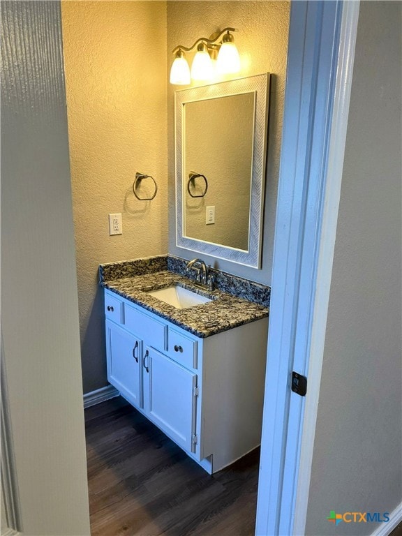 bathroom with hardwood / wood-style flooring and vanity