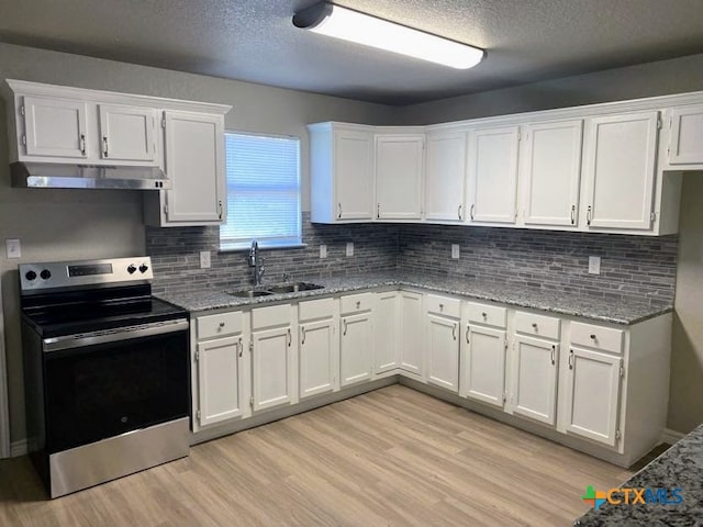 kitchen featuring stainless steel electric range oven, sink, white cabinets, and light stone counters