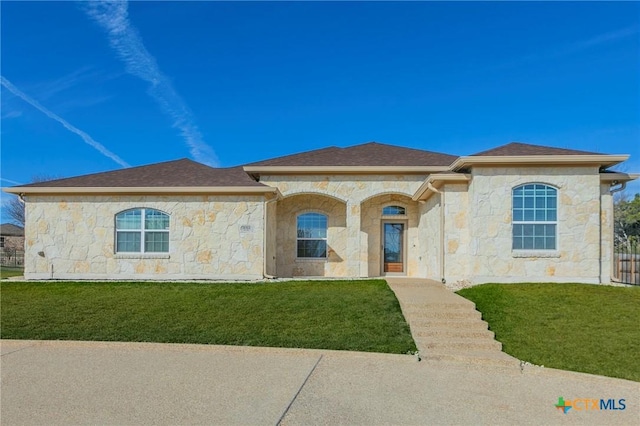 mediterranean / spanish house with a front yard