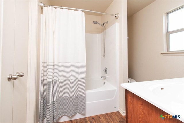 bathroom featuring shower / bathtub combination with curtain, wood finished floors, and vanity