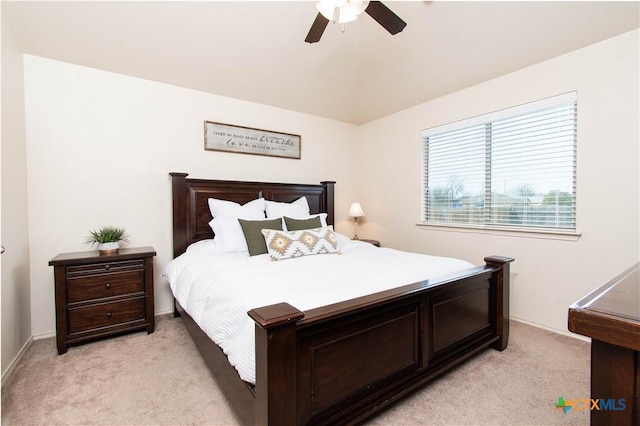 bedroom featuring vaulted ceiling, a ceiling fan, and light carpet