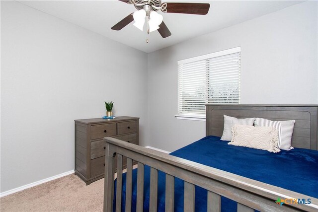 bedroom with baseboards, light carpet, and a ceiling fan