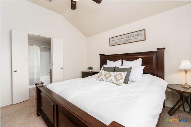 bedroom with a ceiling fan, lofted ceiling, light colored carpet, and ensuite bathroom