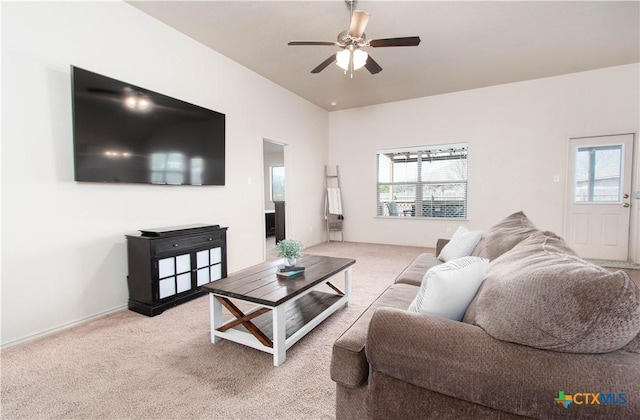 living area with a ceiling fan and carpet floors