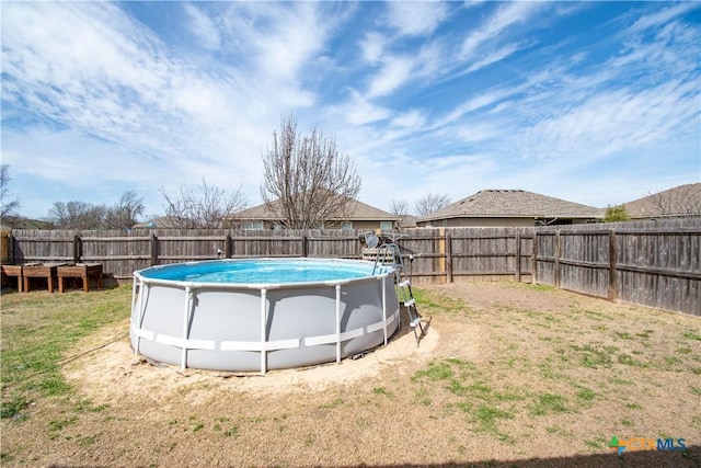 view of yard featuring a fenced in pool and a fenced backyard