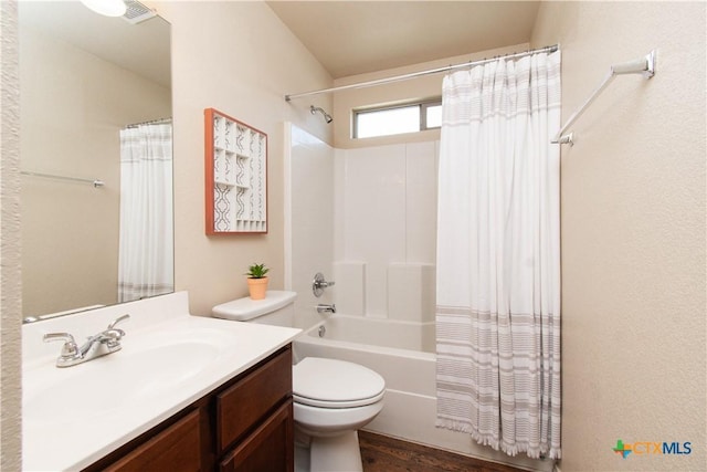 bathroom featuring vanity, wood finished floors, visible vents, toilet, and shower / tub combo with curtain