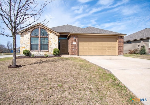 ranch-style house featuring stone siding, concrete driveway, a front yard, a garage, and brick siding