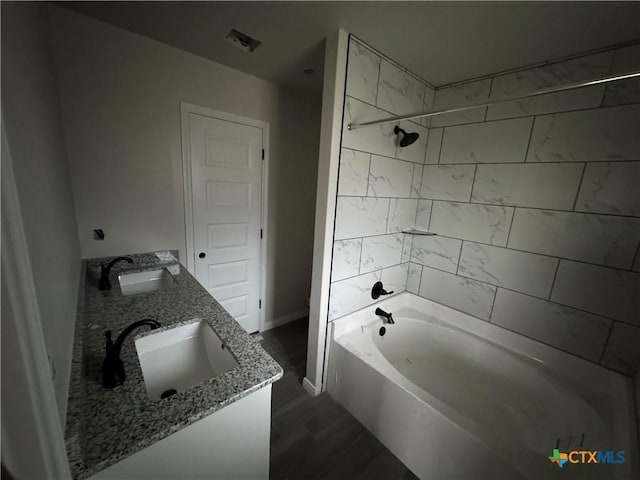 149 Atlas Ave, Killeen, TX 76542 - bathroom featuring double vanity, bathing tub / shower combination, wood finished floors, and baseboards