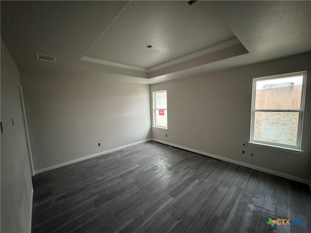 149 Atlas Ave, Killeen, TX 76542 - empty room with a raised ceiling, dark wood finished floors, baseboards, and crown molding