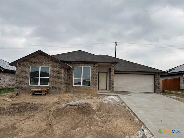 149 Atlas Ave, Killeen, TX 76542 - view of front of house with a garage, driveway, brick siding, and a shingled roof