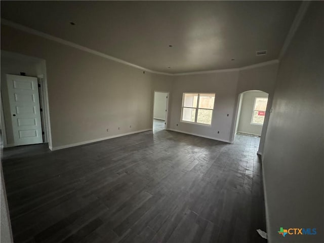 149 Atlas Ave, Killeen, TX 76542 - empty room with arched walkways, ornamental molding, baseboards, and dark wood-style floors