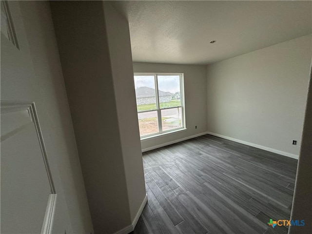 149 Atlas Ave, Killeen, TX 76542 - unfurnished room with baseboards, dark wood-type flooring, and a textured ceiling