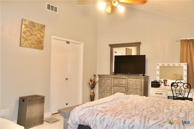 bedroom with vaulted ceiling, a closet, visible vents, and a ceiling fan