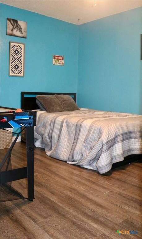 bedroom featuring wood finished floors