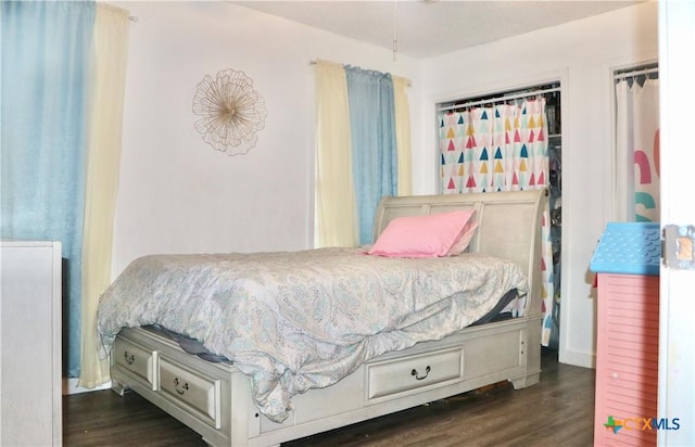 bedroom featuring dark wood finished floors