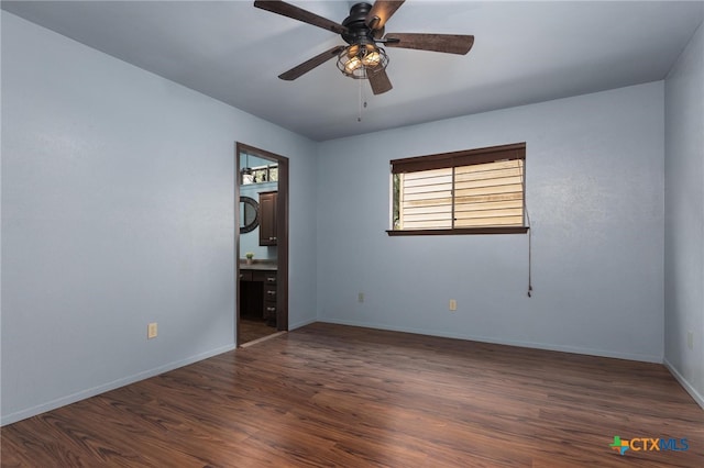 spare room featuring ceiling fan and dark hardwood / wood-style flooring