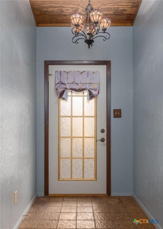 doorway to outside with wood ceiling and a notable chandelier