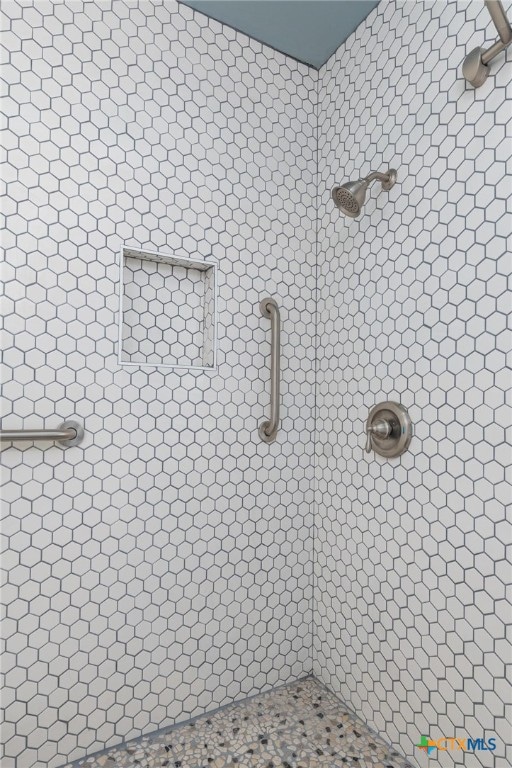 bathroom with a tile shower