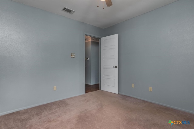 spare room with ceiling fan and carpet floors