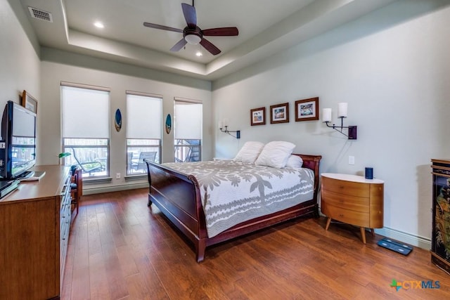 1215 Gruene Vintage, New Braunfels, TX 78130 - bedroom featuring a raised ceiling, dark wood-style floors, recessed lighting, baseboards, and a ceiling fan